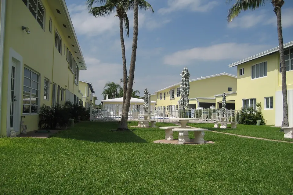 Low-rise townhouse condominiums around a shared pool in Lauderdale-by-the-Sea, Florida