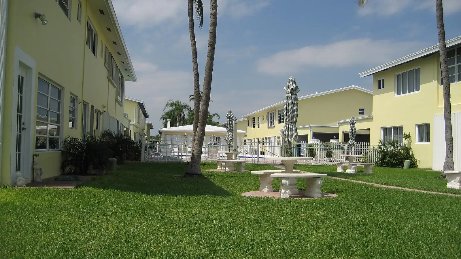 Low-rise townhouse condominiums around a shared pool in Lauderdale-by-the-Sea, Florida